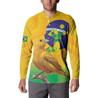 Yellow henley button sweatshirt worn by model with Brazil bird and circular volleyball graphic