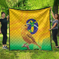 Yellow and green Brasil volleyball quilt spread on grass with bird graphic and diamond quilting