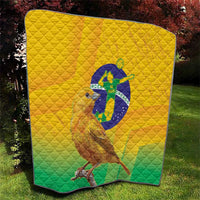 Yellow and green Brasil volleyball quilt outdoors with bird graphic centered on quilted diamonds