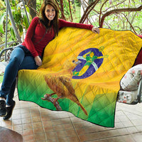 Yellow and green Brasil volleyball quilt draped outdoors with bird graphic and diamond stitching