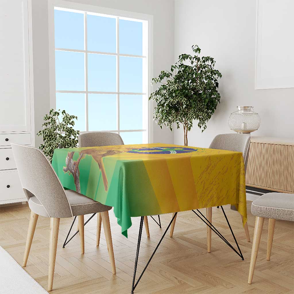 Yellow and green printed volleyball tablecloth with bird and globe artwork, on table.