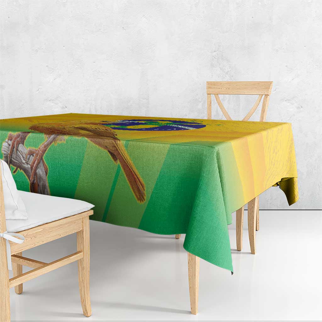 Yellow and green printed volleyball tablecloth with bird-and-globe design, edge overhang.