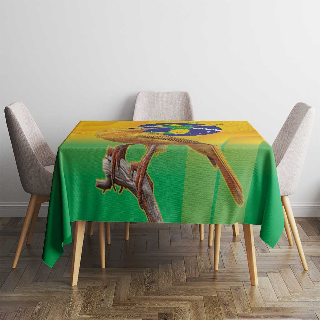 Yellow and green printed volleyball tablecloth with bird and globe artwork on tabletop.
