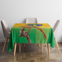 Yellow and green printed volleyball tablecloth with bird and globe artwork on tabletop.