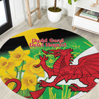 Round green rug with red Welsh dragon, yellow daffodils, and black edge