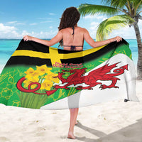 Green sarong worn as beach wrap, showing yellow cross and red dragon emblem