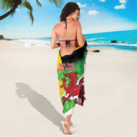 Green St. David's Day sarong tied at waist, red dragon and yellow cross design