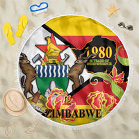 Round fringed beach blanket with Zimbabwe Independence 1980 colorful graphic