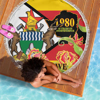 Round fringed beach blanket with Zimbabwe 1980 Independence graphic and map