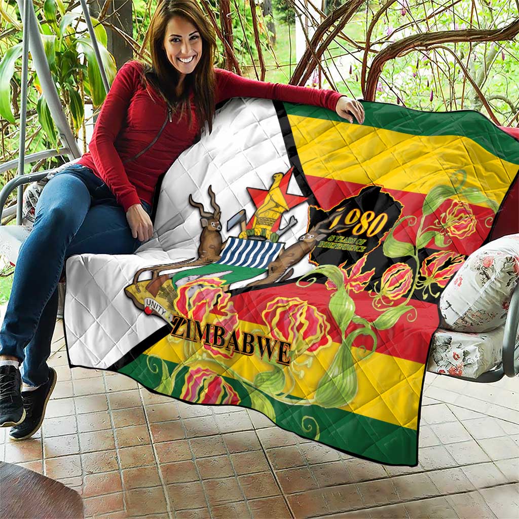 Zimbabwe independence day quilt laid on sofa cushions; quilted flag design with lions