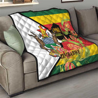 Zimbabwe independence day quilt folded on couch, flag colors with lions and “Zimbabwe”