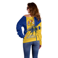 Women’s off-shoulder sweater with blue/yellow back crest and Celtic Festival print