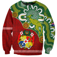 Green and red sweatshirt with stylized animal emblem and crest artwork