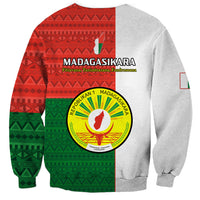 Unisex crewneck sweatshirt with large Madagascar emblem and red-green patterned panels.