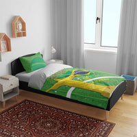Green bedding set on bed, duvet and pillowcases with Christ statue and Brazil map