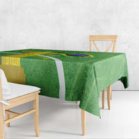 Green tablecloth draped over dining table with Brazil map and flag print