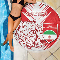 Round red-and-white beach blanket with lion graphic, Iran football shield, and fringe border