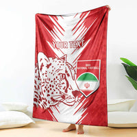 Red and white football blanket draped with leopard graphic and Iran national football crest