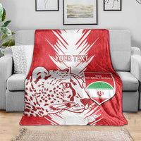 Red and white football blanket with leopard graphic and Iran national football crest on sofa