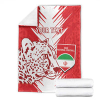 Folded red and white football blanket with leopard graphic and Iran national football crest