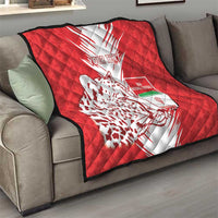 Red quilt throw on sofa with white burst design, leopard silhouette, and "Your Text"