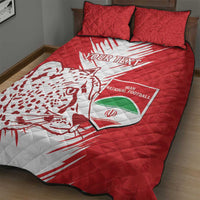 Red quilt bed set on bed with 2 pillowcases, large white action graphic, Iran football