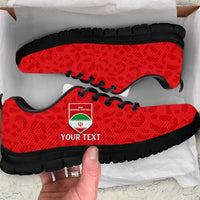 Red leopard-pattern football sneakers with black sole, black laces, side logo patch