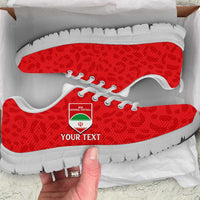 Red leopard-pattern football sneakers with white sole, white laces, side logo patch