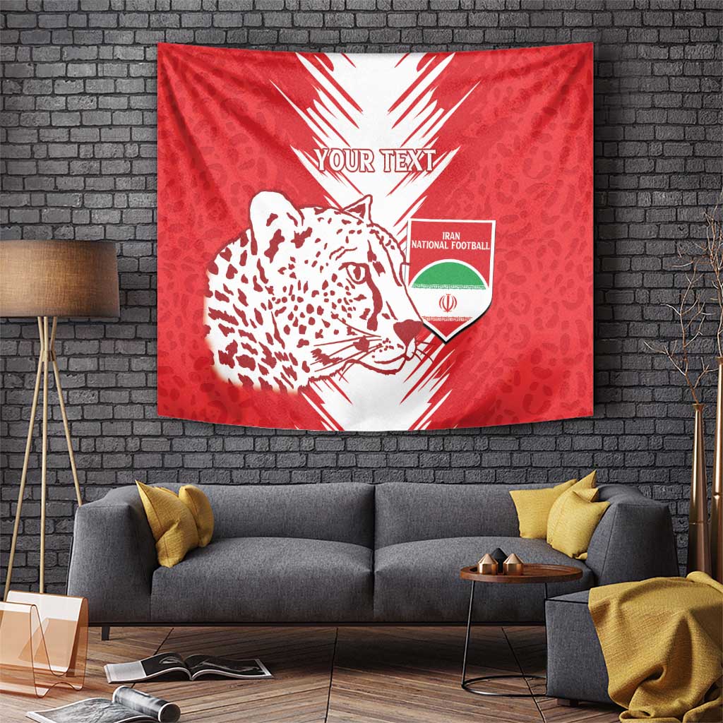 Red tapestry showing leopard-pattern cat face, Iran football crest and 'YOUR TEXT' headline