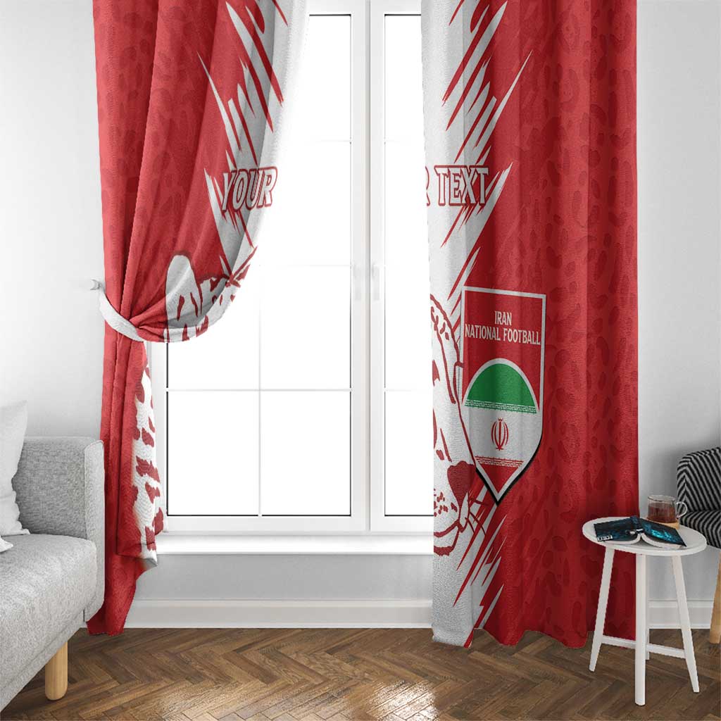 Red window curtains with white leopard artwork and Iran football shield, side view at window.