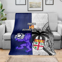 Rugby blanket with blue left side, white patterned right side, black motifs and shield