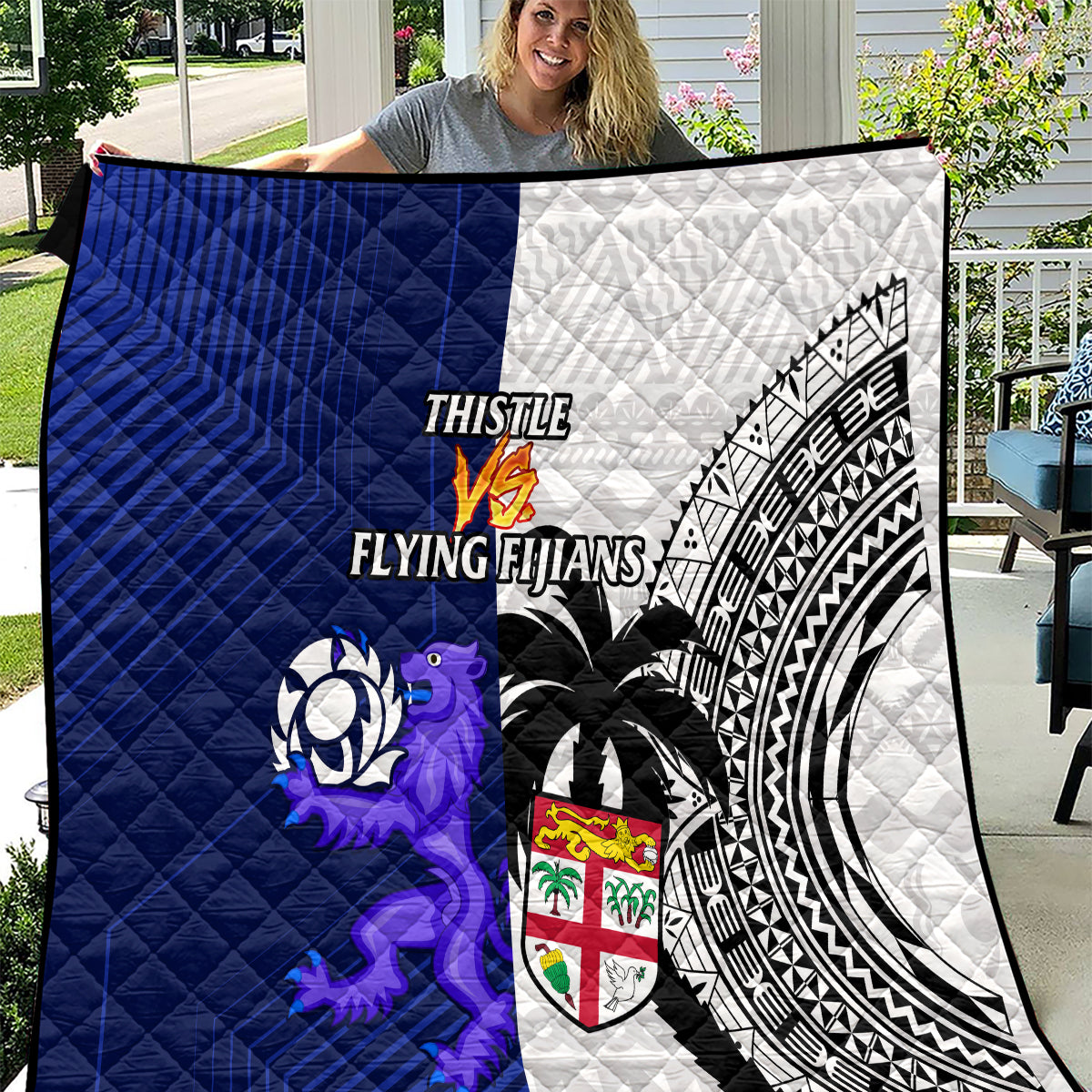 Blue and white quilt blanket with geometric patterns, lion graphic, and crest shield.