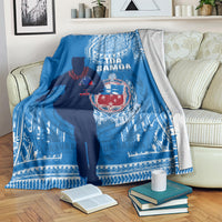 Blue rugby blanket over an armchair, showing player silhouette and white patterned border