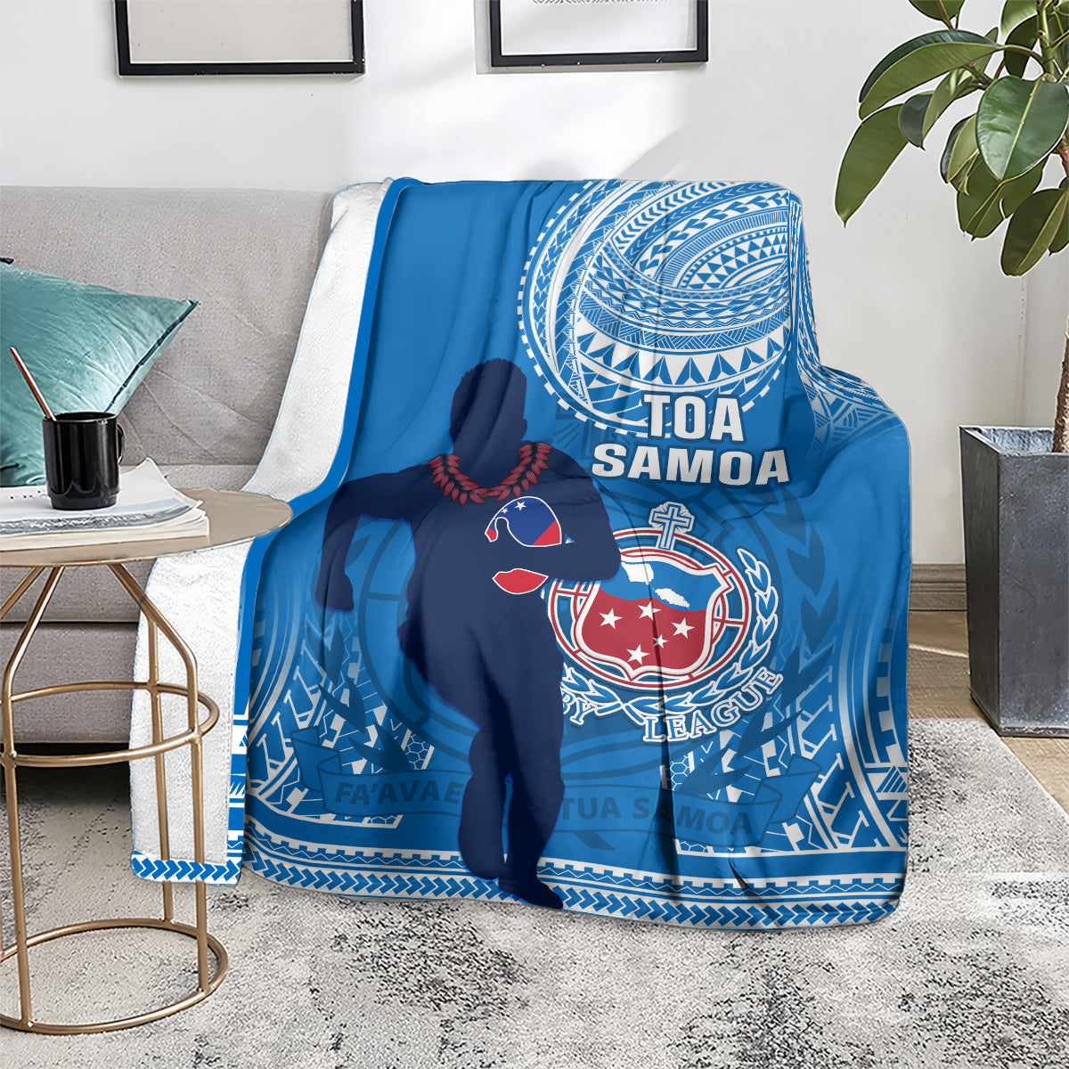 Blue rugby blanket on a couch with Tofa Samoa text, player graphic, and tribal motif