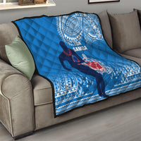Blue Samoa rugby quilt on gray sofa with quilted diamond texture and emblem