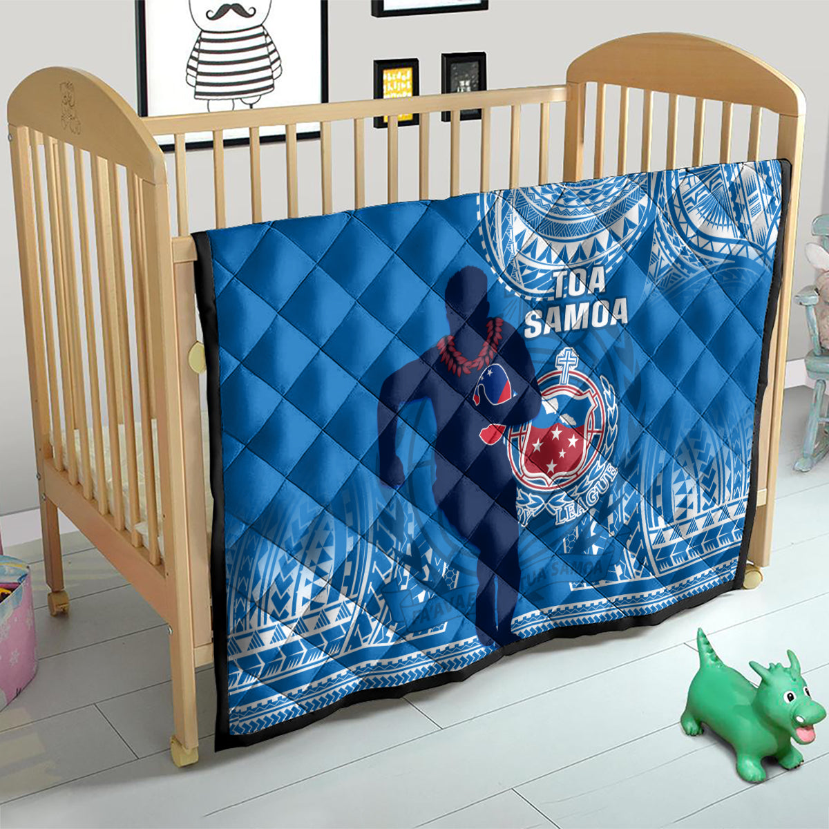 Blue Samoa rugby quilt over crib mattress with white spiral and emblem artwork