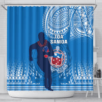 Blue rugby shower curtain hanging on a rod, with player silhouette and Toa Samoa crest