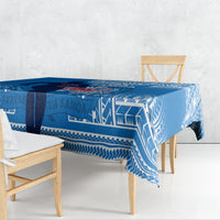 Blue rugby tablecloth with white tribal pattern, draped over a dining table
