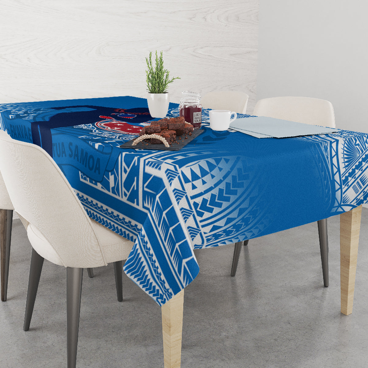 Blue rugby tablecloth with white geometric border, set with tableware