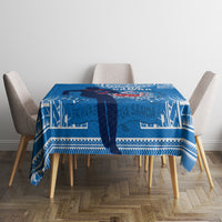 Blue rugby tablecloth with white patterned panels, centered on a dining table