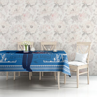 Blue rugby tablecloth with white geometric strip pattern on a dining table