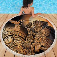 Round fringed beach blanket with Aztec hummingbird warrior illustration, viewed from above