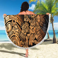 Round fringed beach blanket with Aztec hummingbird warrior graphic, held outdoors on sand