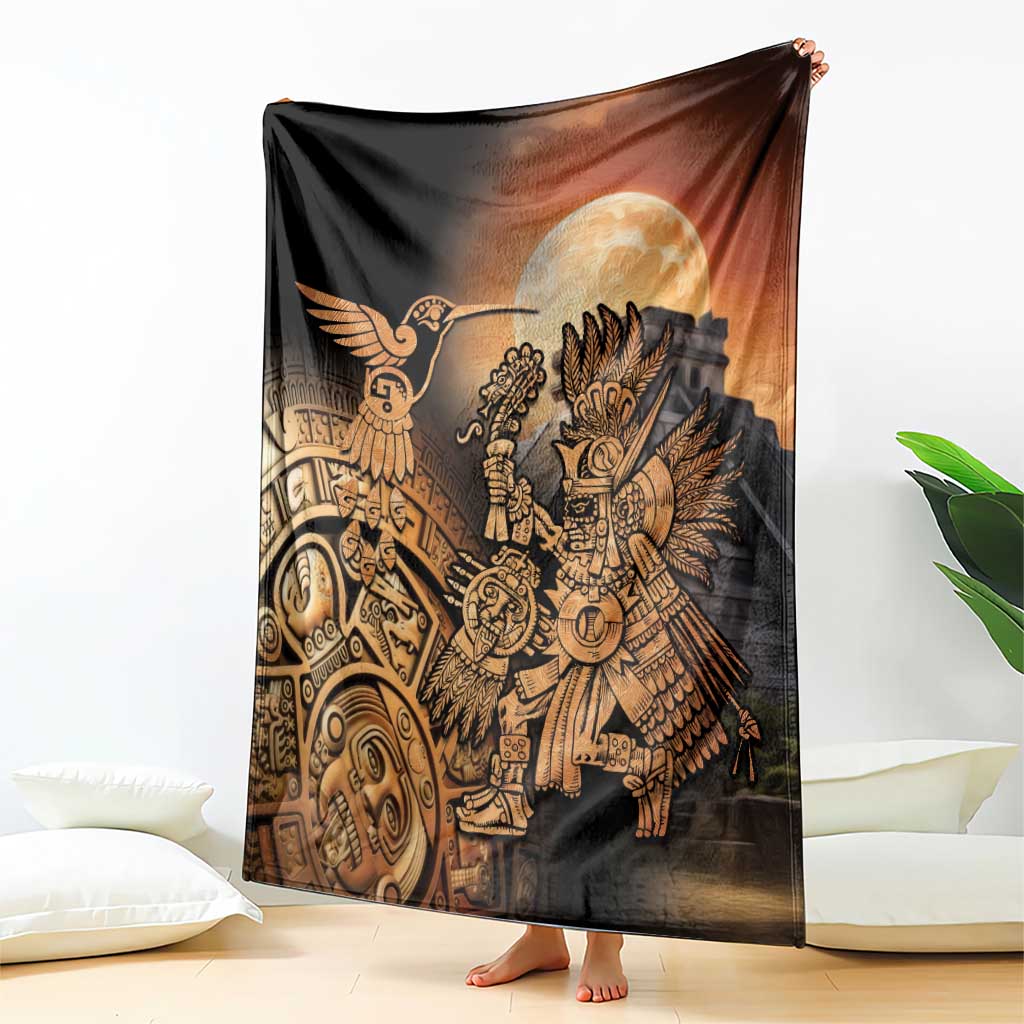 Black Aztec blanket with gold hummingbird and warrior under large moon, held upright