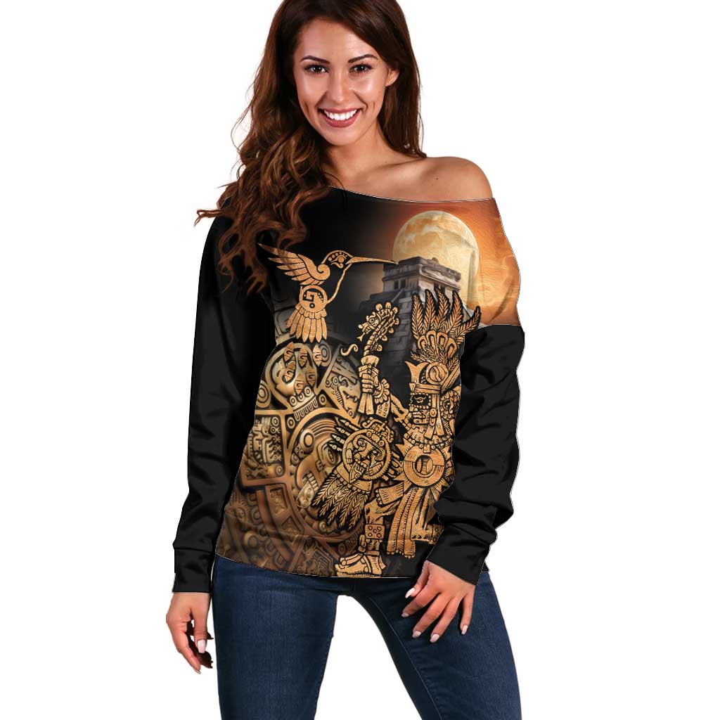 Women's off-shoulder black sweater with gold Aztec-style hummingbird graphic and moon