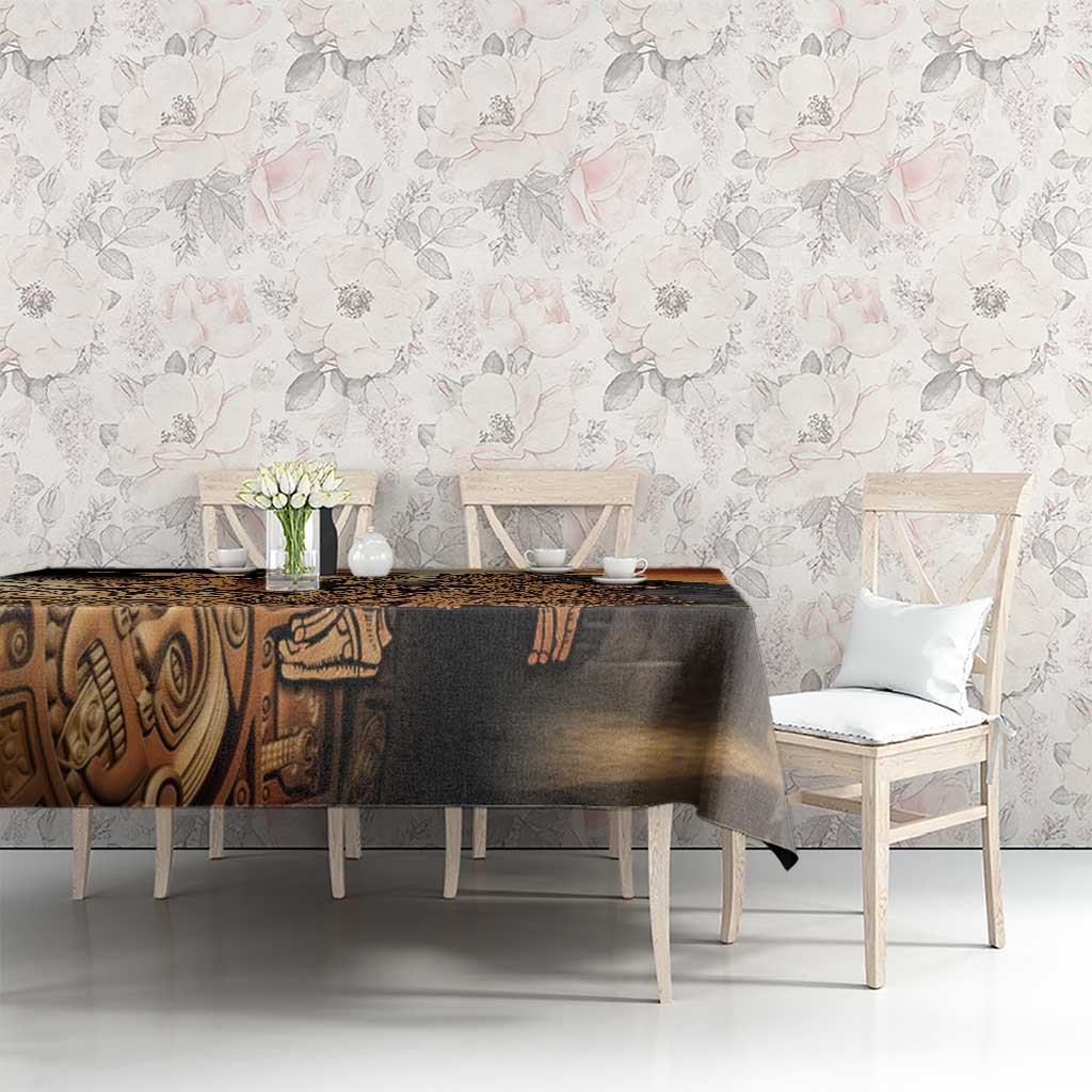 Aztec warrior tablecloth on dining table, black base with gold hummingbird artwork