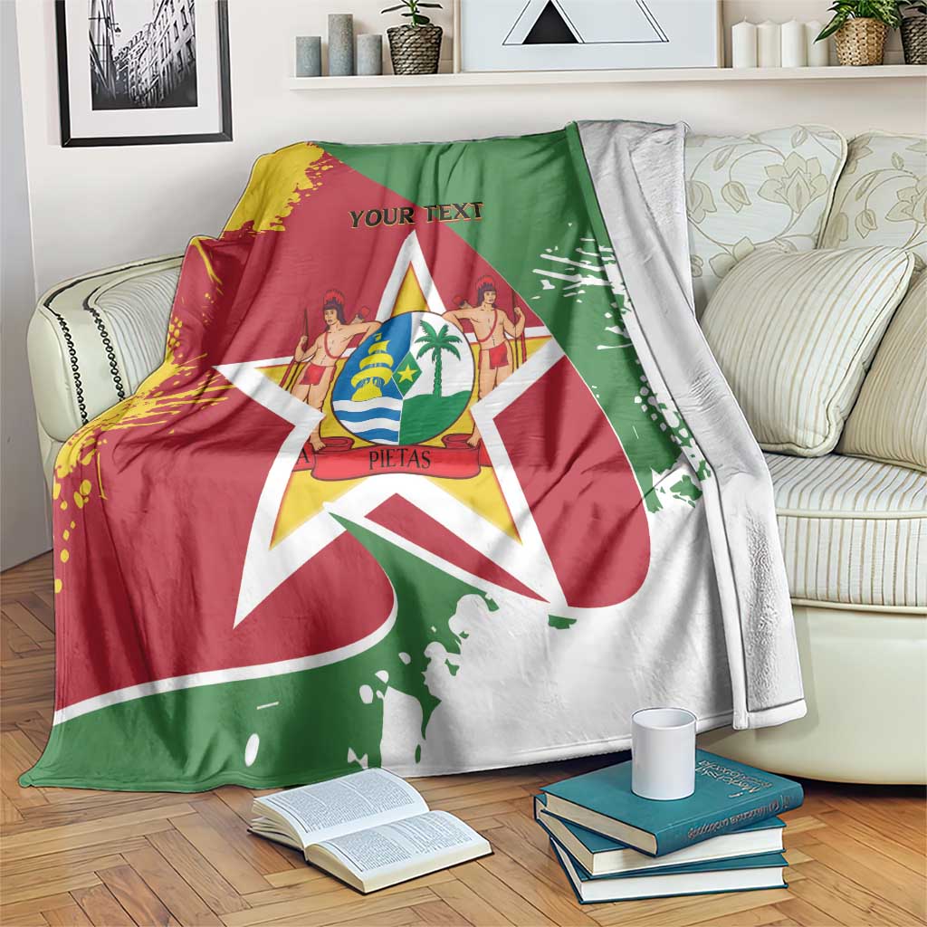 Flag-style blanket coat with Suriname crest and star in red, green, and yellow, draped on sofa