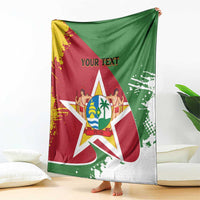 Flag-style Suriname blanket coat with crest star and "YOUR TEXT", hanging over couch