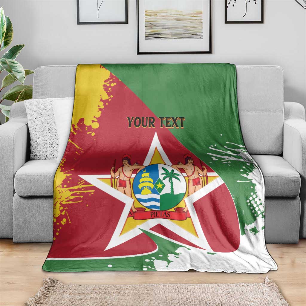 Suriname flag blanket coat with coat-of-arms star, red and green with yellow accents, on gray sofa