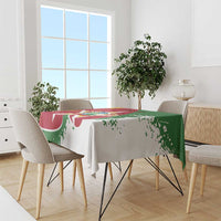 Suriname flag-style tablecloth draped on dining table, red and green emblem print